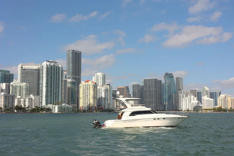 Slide: The Image of Sea Ray 480 Sedan Bridge yacht cruising near city skyline, 2000 model. - 2