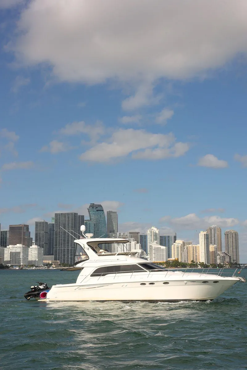 Slide: The Image of 2000 Sea Ray 480 Sedan Bridge yacht cruising near city skyline. - 3
