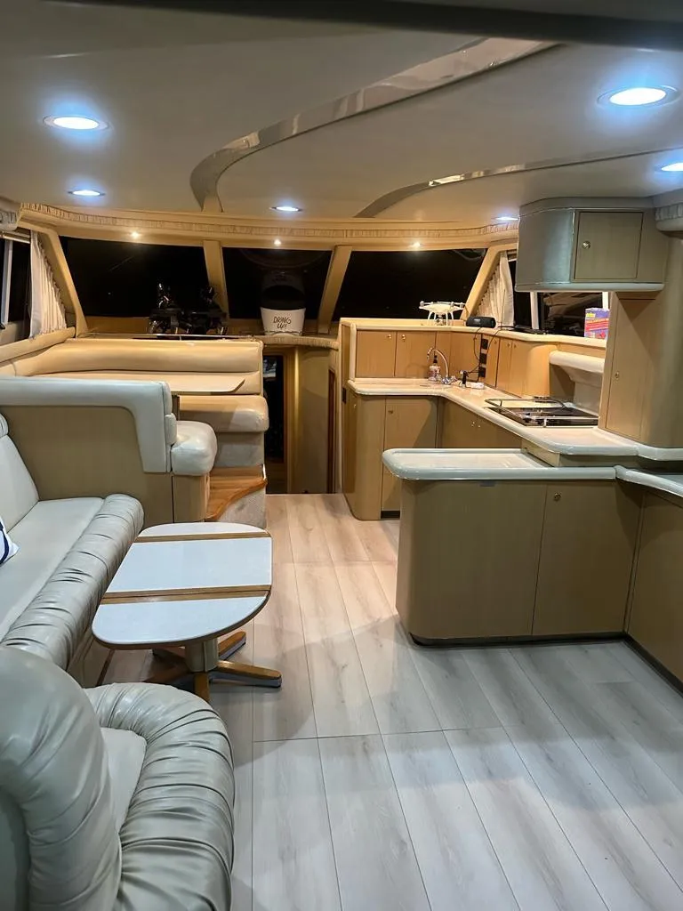 Slide: The Image of Luxurious interior of 2000 Sea Ray 480 Sedan Bridge yacht with modern furnishings. - 5