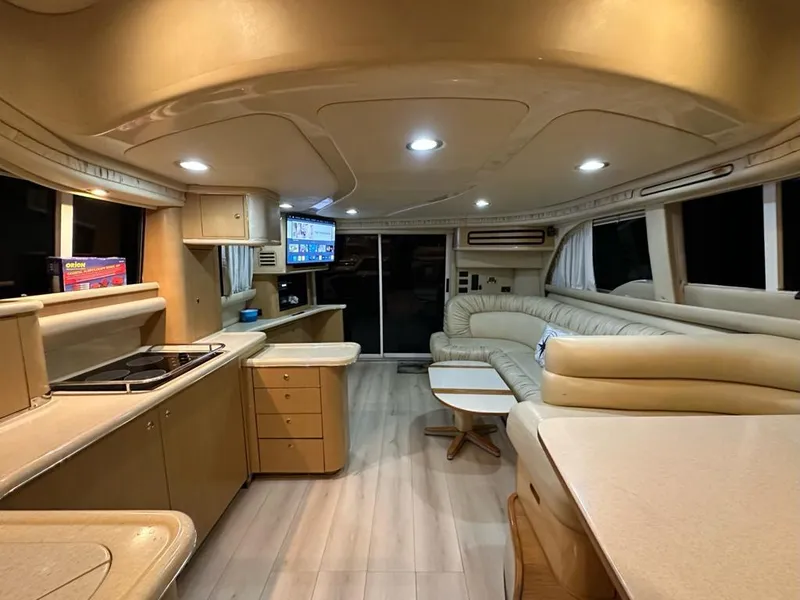 Slide: The Image of Interior of 2000 Sea Ray 480 Sedan Bridge yacht, featuring luxurious seating and modern amenities. - 7