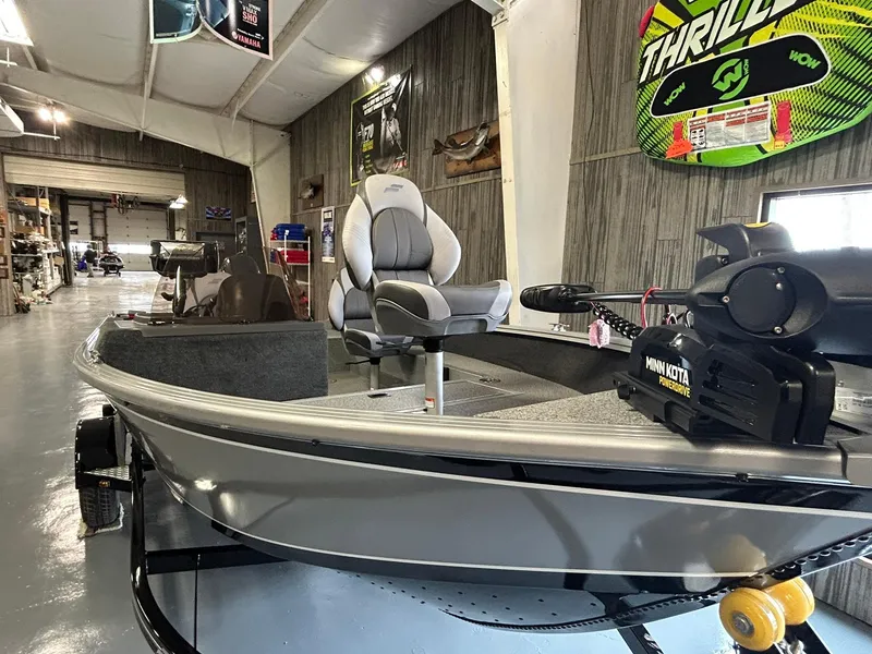 Slide: The Image of 2025 Starcraft Stealth 166SC boat in showroom, featuring Minn Kota motor. - 11