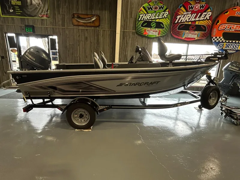 Slide: The Image of 2025 Starcraft Stealth 166SC boat on trailer in showroom. - 12