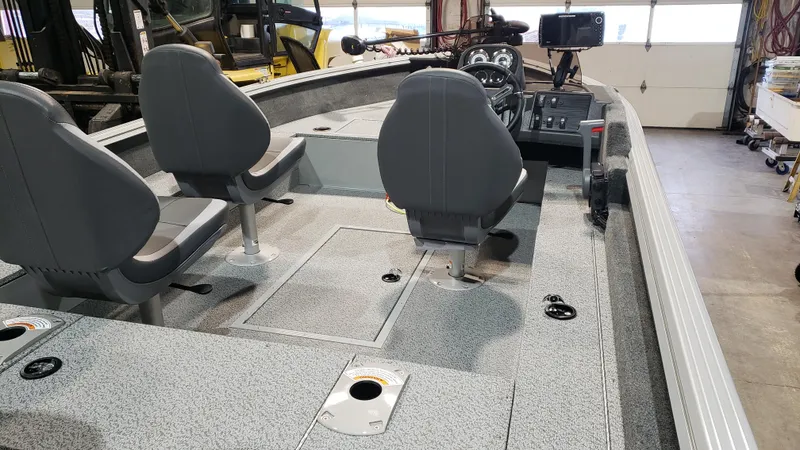 Slide: The Image of 2025 Starcraft Stealth 166SC boat interior with dual seats and control panel. - 7