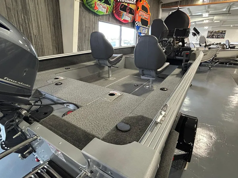 Slide: The Image of 2025 Starcraft Stealth 166SC boat interior with seating and motor in showroom. - 9