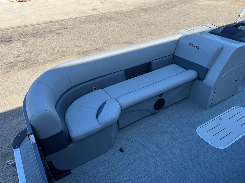 Slide: The Image of 2025 Bentley Pontoons Legacy 243 Navigator interior with gray seating and carpeted flooring. - 11