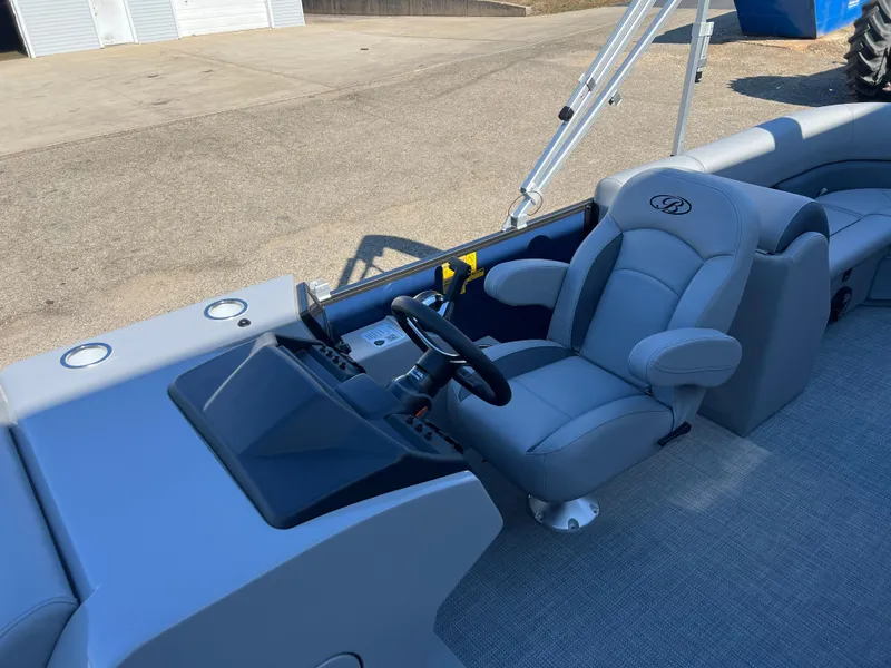 Slide: The Image of 2025 Bentley Pontoons Legacy 243 Navigator interior with steering console and plush seating. - 14