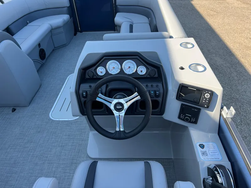 Slide: The Image of 2025 Bentley Pontoons Legacy 243 Navigator dashboard with steering wheel and modern controls. - 20