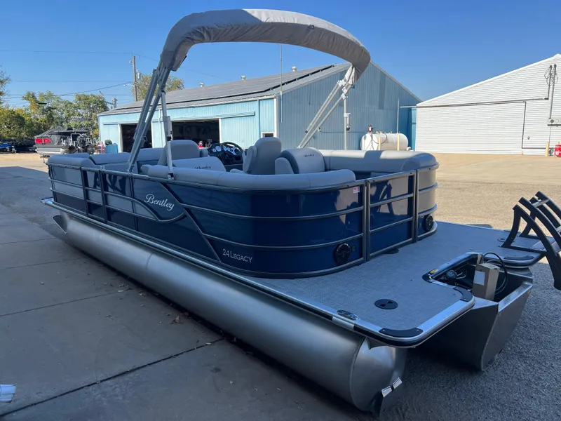 Slide: The Image of 2025 Bentley Pontoons Legacy 243 Navigator, blue pontoon boat parked outdoors. - 5