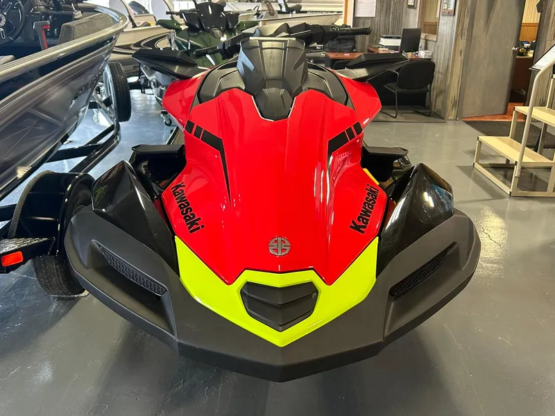 Slide: The Image of 2025 Kawasaki Jetski Ultra 310X in showroom, featuring sleek red and black design. - 2