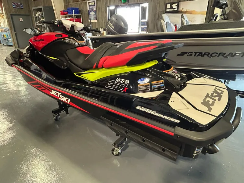 Slide: The Image of 2025 Kawasaki Jetski Ultra 310X in showroom, black and red design. - 7