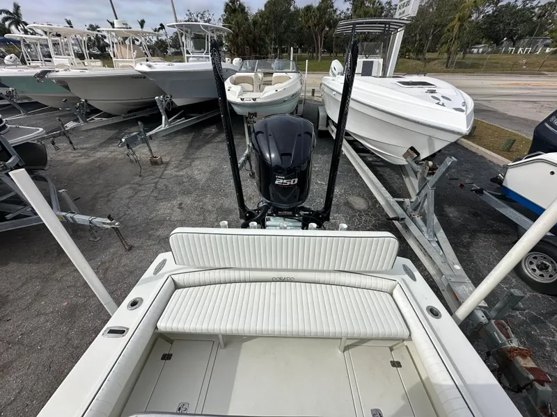 Slide: The Image of 2008 Dorado 23 Classic boat with outboard motor, parked on a trailer. - 13