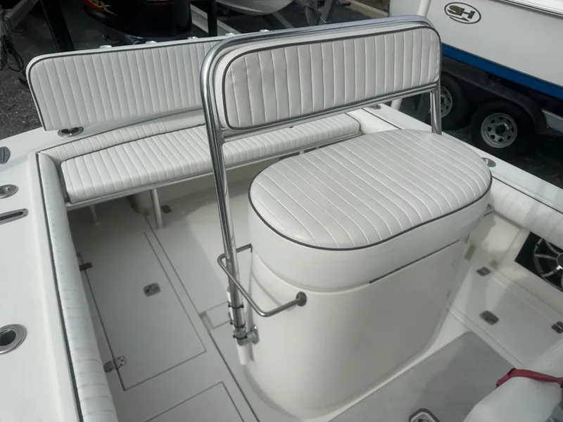 Slide: The Image of 2008 Dorado 23 Classic boat interior with white cushioned seating and storage compartments. - 15