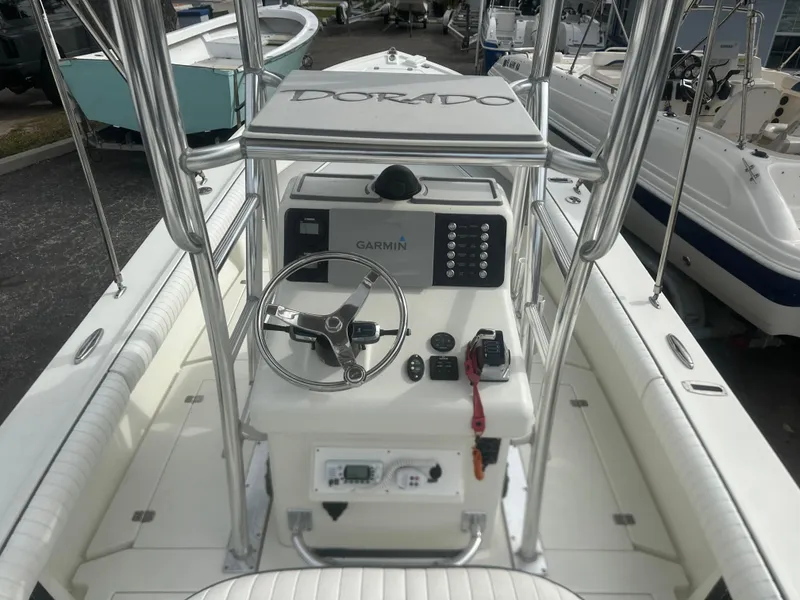 Slide: The Image of 2008 Dorado 23 Classic boat cockpit with steering wheel and Garmin navigation system. - 22