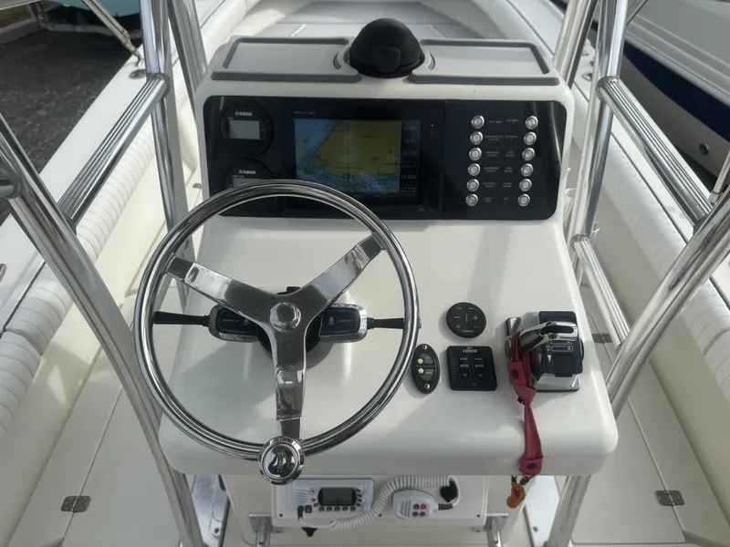 Slide: The Image of Steering console of 2008 Dorado 23 Classic boat with navigation controls. - 23