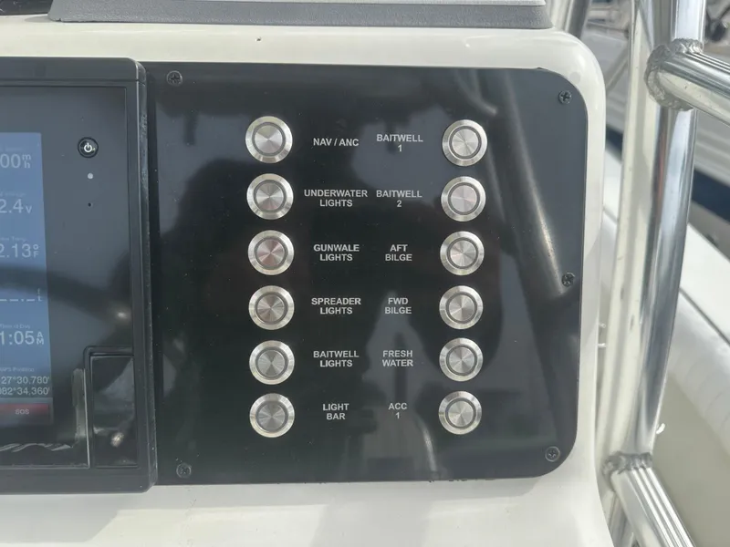 Slide: The Image of Control panel of a 2008 Dorado 23 Classic boat with labeled switches. - 26