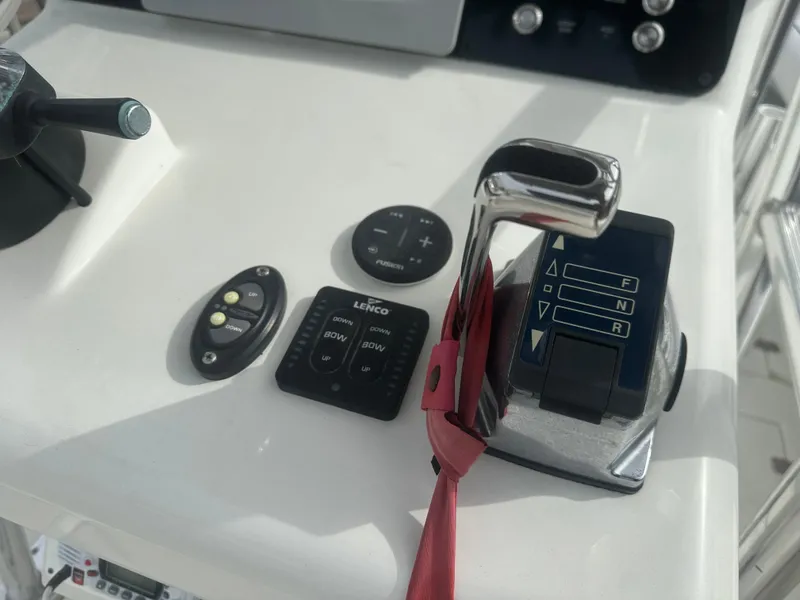 Slide: The Image of Control panel of a 2008 Dorado 23 Classic boat with throttle and switches. - 27