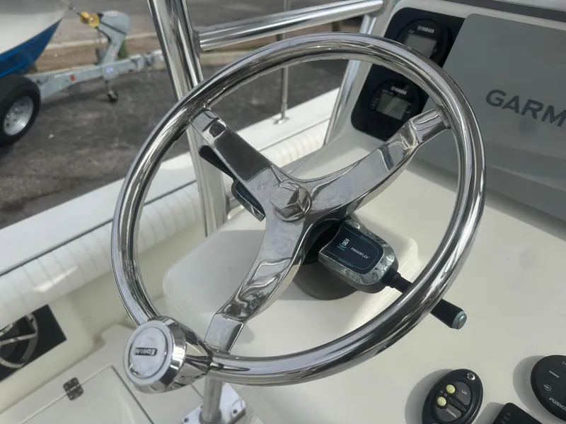 Slide: The Image of Steering wheel of 2008 Dorado 23 Classic boat with Garmin controls. - 28
