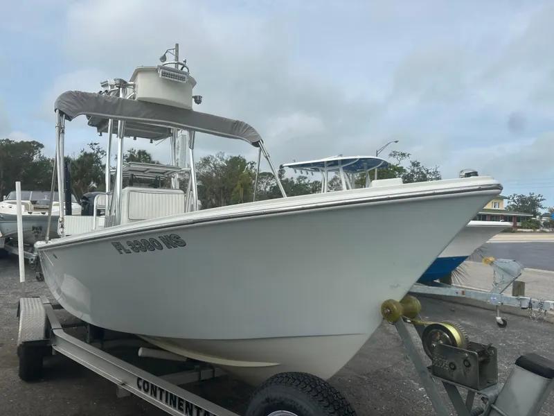 Slide: The Image of 2008 Dorado 23 Classic boat on trailer, parked outdoors, cloudy sky background. - 3