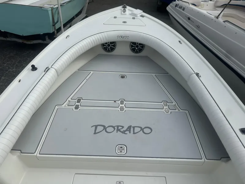 Slide: The Image of 2008 Dorado 23 Classic boat deck with logo, featuring spacious seating and storage. - 36