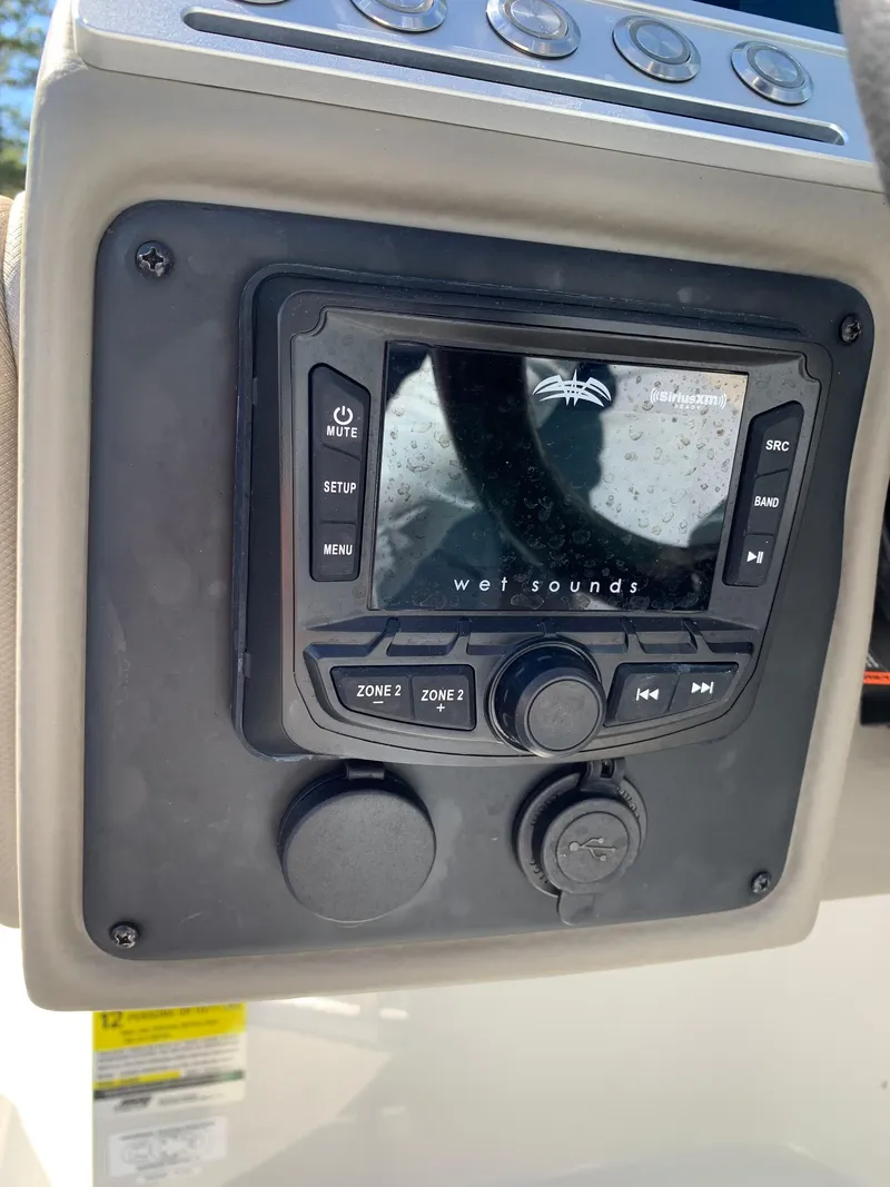 Slide: The Image of Crownline E235XS 2023 dashboard featuring Wet Sounds audio system controls. - 10