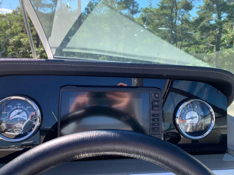 Slide: The Image of 2023 Crownline E235XS dashboard with speedometer and RPM gauges. - 7