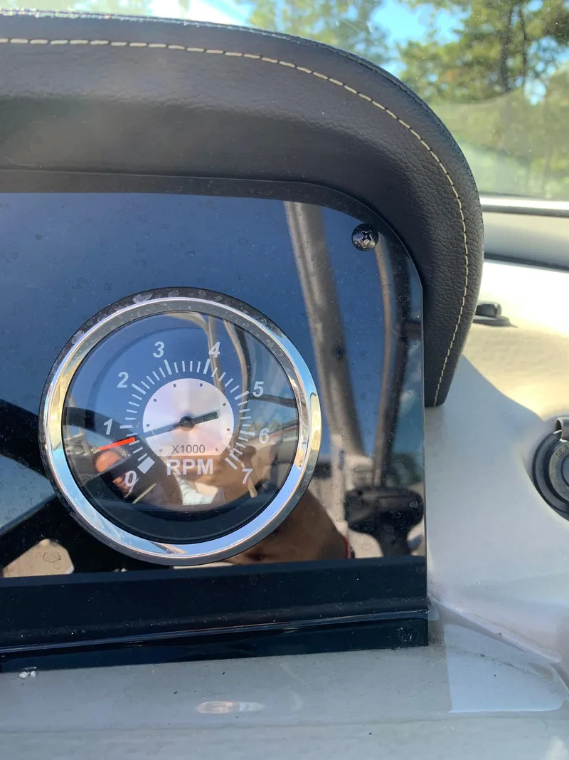 Slide: The Image of Close-up of 2023 Crownline E235XS RPM gauge on boat dashboard. - 9