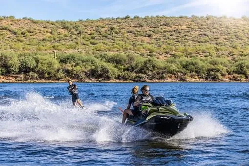 Slide: The Image of 2025 Kawasaki JET SKI ULTRA 160LX on a scenic lake with riders enjoying the water. - 12