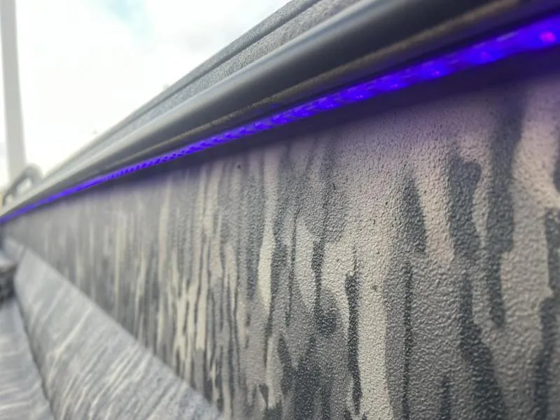 Slide: The Image of 2024 Havoc Boats 1750 MSTC Limited Edition with camo pattern and purple LED lighting. - 14