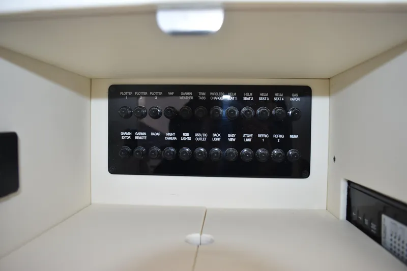 Slide: The Image of Control panel of 2025 Regal 36 XO boat with labeled switches and buttons. - 56