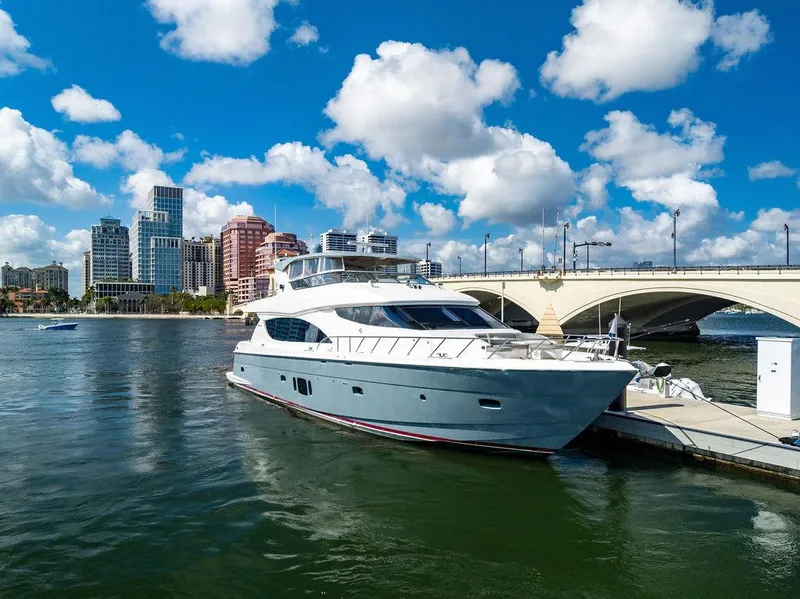 Slide: The Image of 2013 Hatteras 80 Motor Yacht docked near city skyline and bridge. - 12