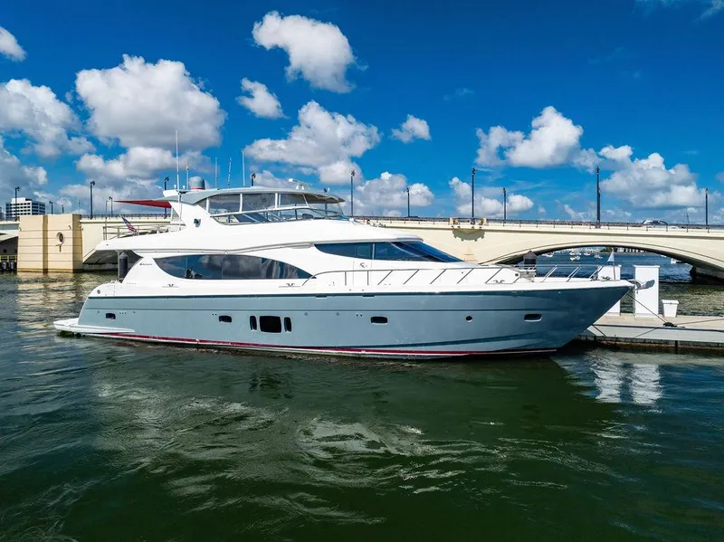 Slide: The Image of 2013 Hatteras 80 Motor Yacht docked under a blue sky. - 2