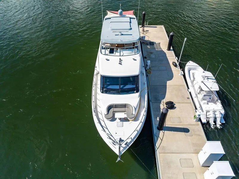 Slide: The Image of 2013 Hatteras 80 Motor Yacht docked beside a smaller boat. - 6