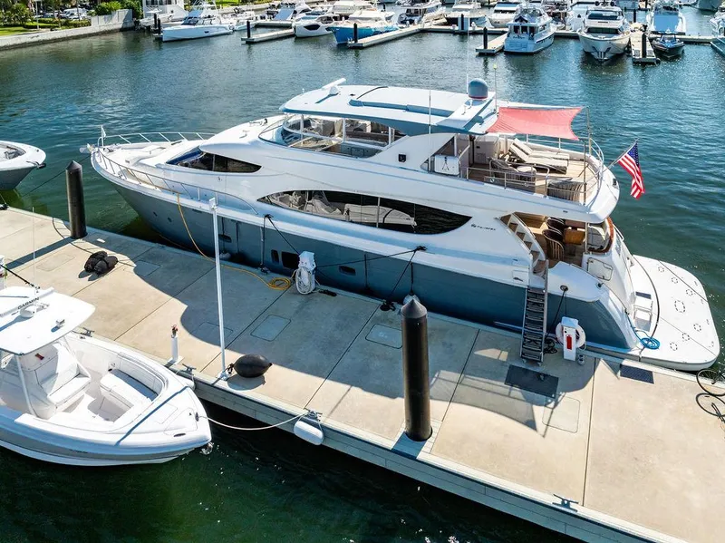 Slide: The Image of 2013 Hatteras 80 Motor Yacht docked at marina, featuring spacious deck and sleek design. - 8