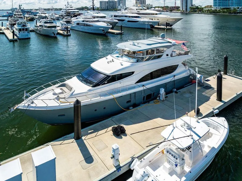 Slide: The Image of 2013 Hatteras 80 Motor Yacht docked at marina with other luxury boats. - 9