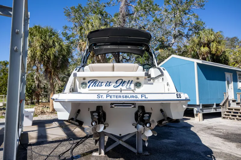 Slide: The Image of 2017 Formula 330 Crossover Bowrider boat in St. Petersburg, FL, docked with trees and a blue building. - 10