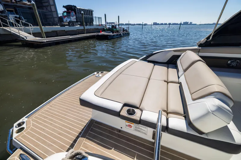 Slide: The Image of 2017 Formula 330 Crossover Bowrider at dock, featuring spacious seating and sleek design. - 15