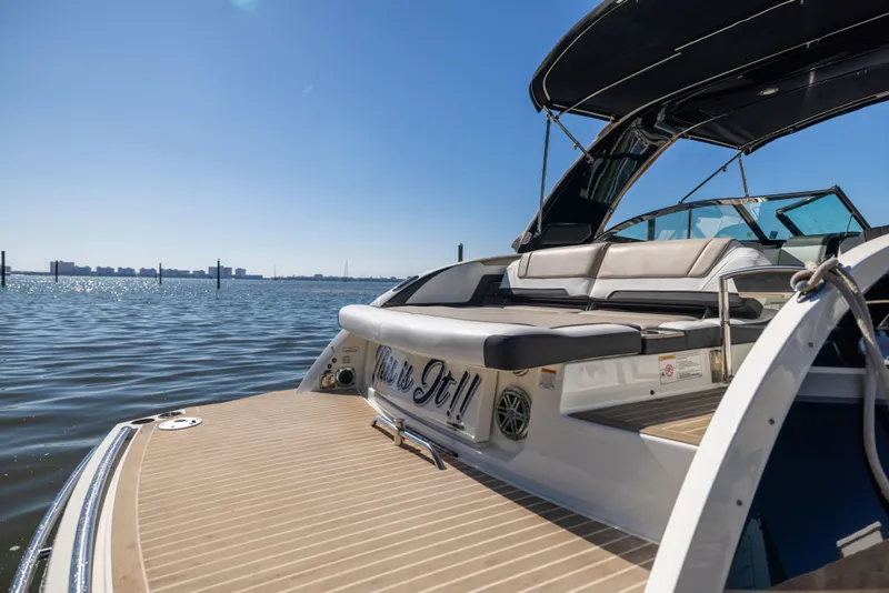 Slide: The Image of 2017 Formula 330 Crossover Bowrider on calm water, featuring spacious seating and sleek design. - 16