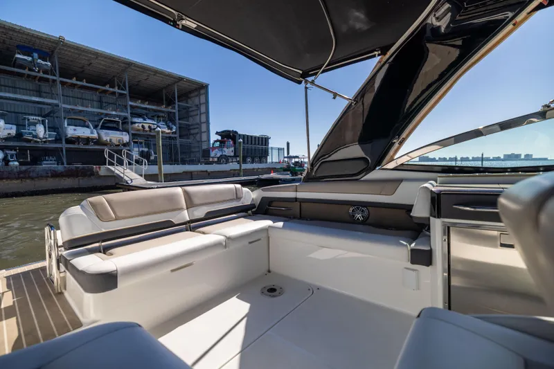 Slide: The Image of 2017 Formula 330 Crossover Bowrider interior with seating, docked near marina. - 19