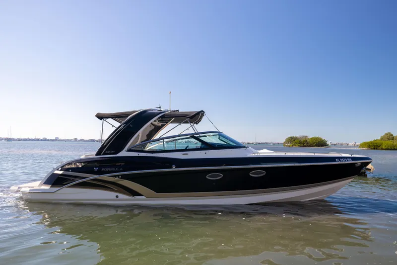 Slide: The Image of 2017 Formula 330 Crossover Bowrider in calm waters, side view. - 2