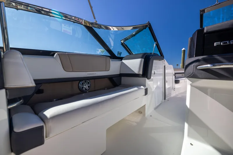 Slide: The Image of 2017 Formula 330 Crossover Bowrider interior with seating and blue sky background. - 21