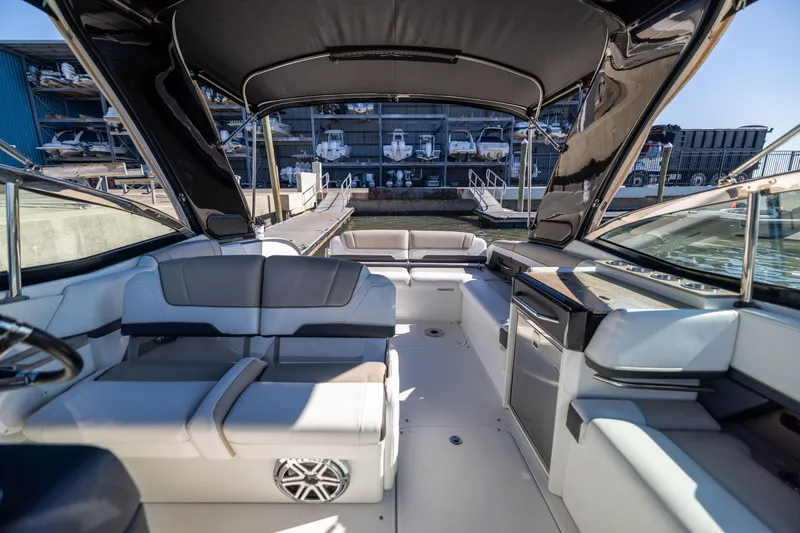 Slide: The Image of 2017 Formula 330 Crossover Bowrider interior with seating and canopy, docked at marina. - 22