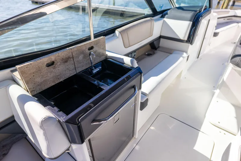 Slide: The Image of 2017 Formula 330 Crossover Bowrider interior with sink and seating area. - 24