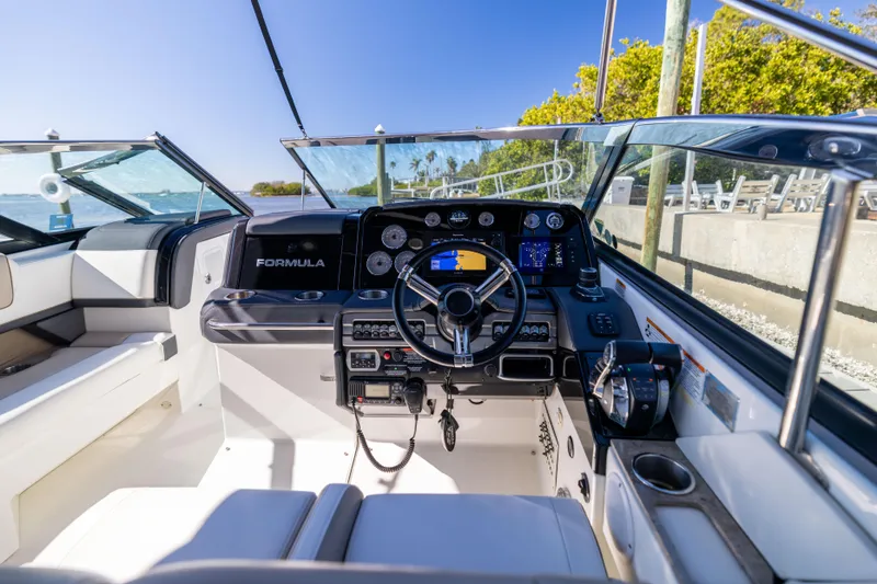 Slide: The Image of 2017 Formula 330 Crossover Bowrider cockpit with steering wheel and control panel. - 26
