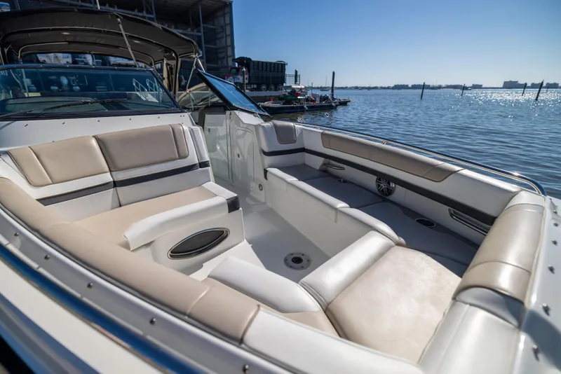 Slide: The Image of 2017 Formula 330 Crossover Bowrider with spacious seating, docked by the water. - 28