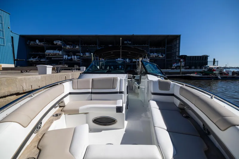 Slide: The Image of 2017 Formula 330 Crossover Bowrider docked, showcasing spacious seating and sleek design. - 33