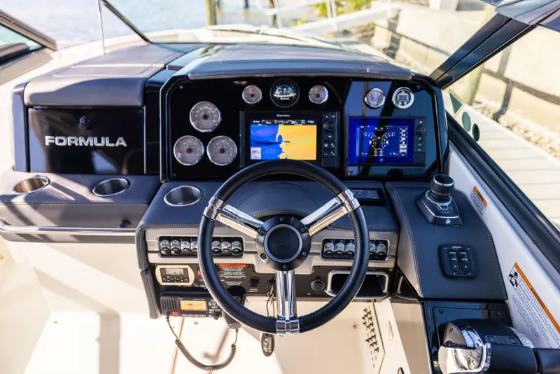 Slide: The Image of 2017 Formula 330 Crossover Bowrider dashboard with steering wheel and navigation displays. - 34
