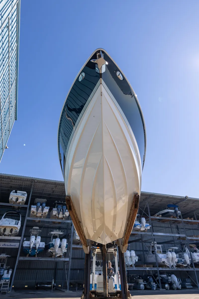 Slide: The Image of 2017 Formula 330 Crossover Bowrider boat in storage, viewed from below against a clear sky. - 4
