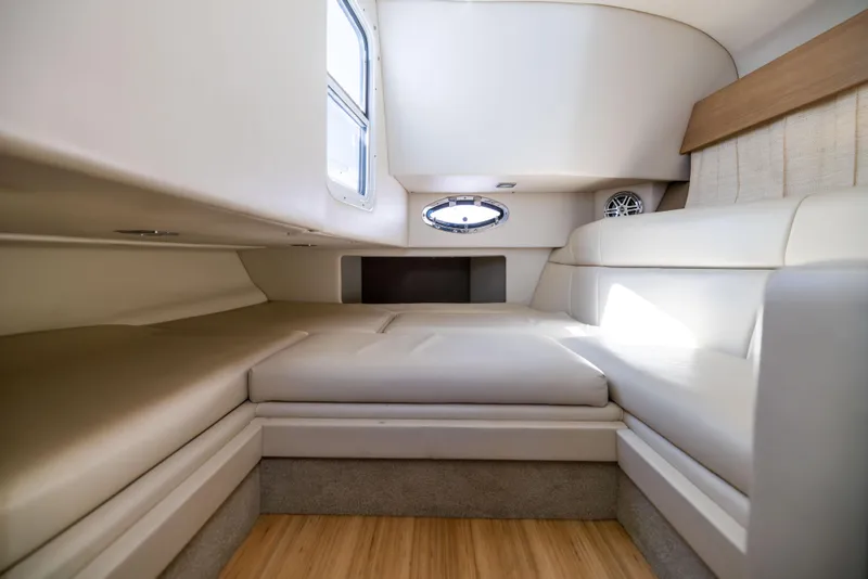 Slide: The Image of 2017 Formula 330 Crossover Bowrider interior with beige seating and wood flooring. - 42