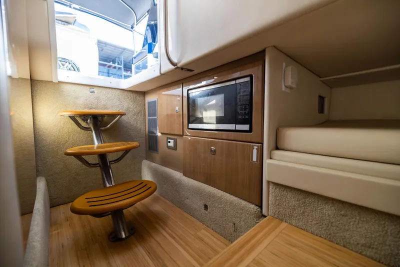 Slide: The Image of 2017 Formula 330 Crossover Bowrider interior with microwave and wooden steps. - 44