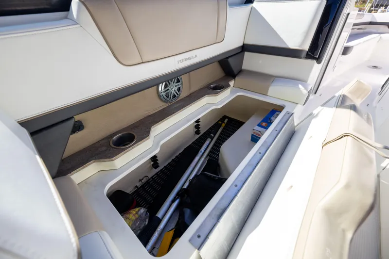 Slide: The Image of 2017 Formula 330 Crossover Bowrider interior storage compartment with various items. - 47